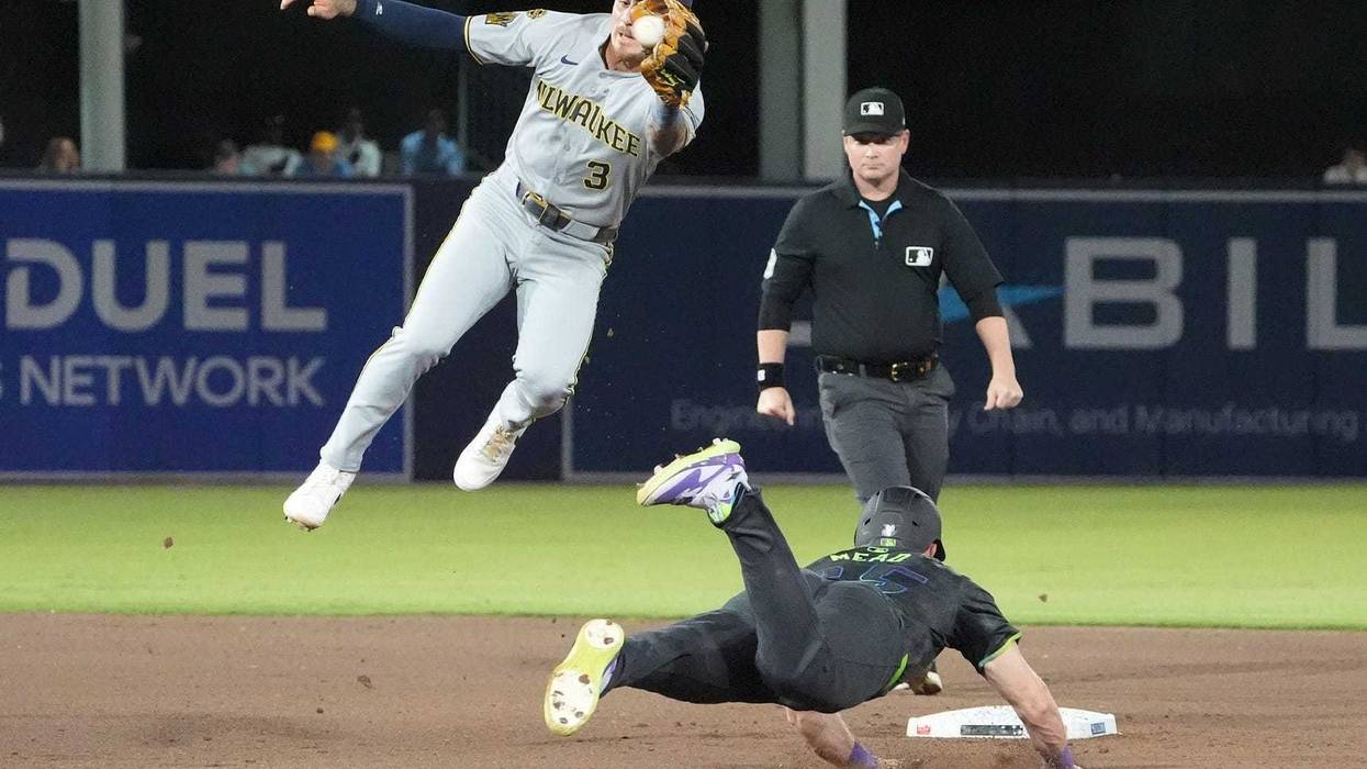 May 9, 2025; Tampa, Florida, USA; Tampa Bay Rays first base Curtis Mead (25) steals second as Milwaukee Brewers shortstop Joey Ortiz (3) leaps for the ball during the seventh inning at George M. Steinbrenner Field. Mandatory Credit: Dave Nelson-Imagn Images