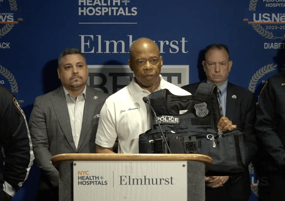 Mayor Adams holds up a bulletproof vest worn by one of the officers who was shot, saying it saved his life