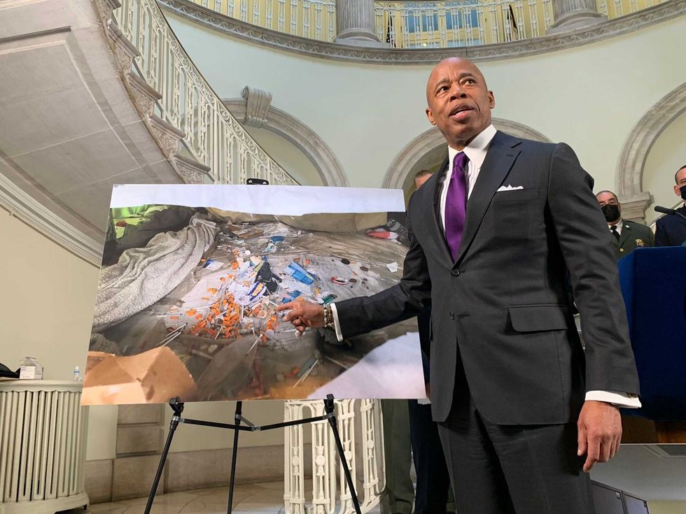 Mayor Adams points to an encampment where he said 500 hypodermic needles were found