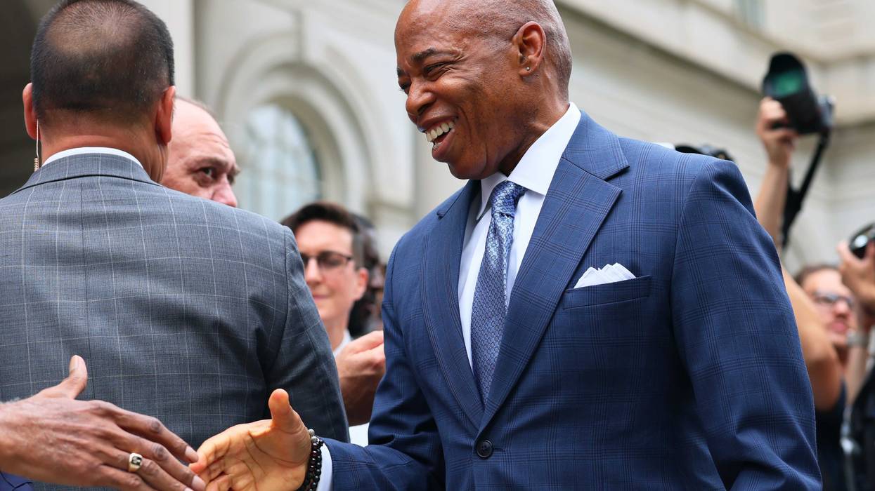 Mayor Eric Adams arrives for a press conference at City Hall this summer
