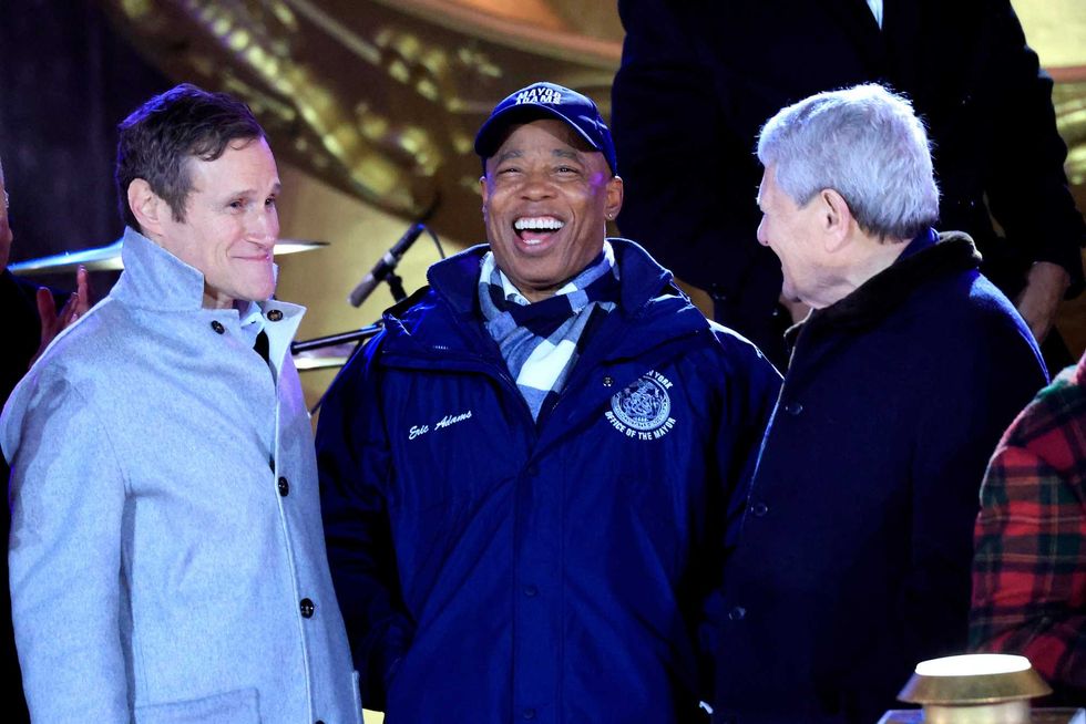 Mayor Eric Adams (C) stands onstage during the Rockefeller Center tree lighting ceremony in New York on December 4, 2024