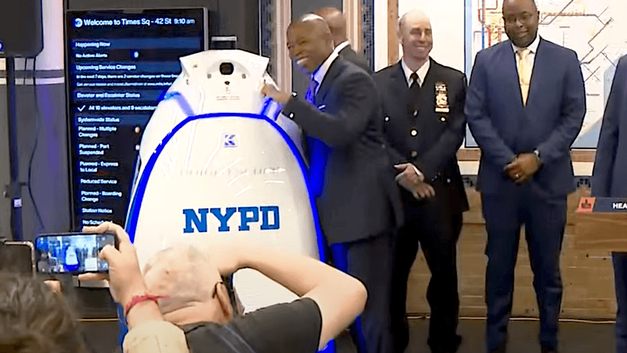 Mayor Eric Adams poses beside K5 at a news conference inside the Times Square subway station on Sept. 22, 2023