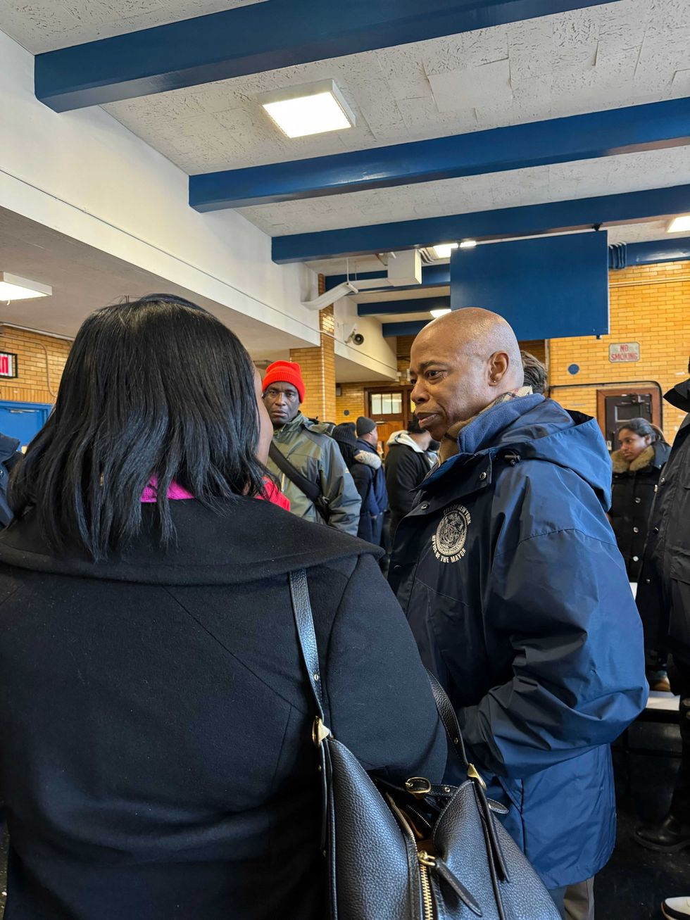 Mayor Eric Adams speaks with displaced residents at P.S. 76, where a temporary shelter was set up on Jan. 10, 2025.