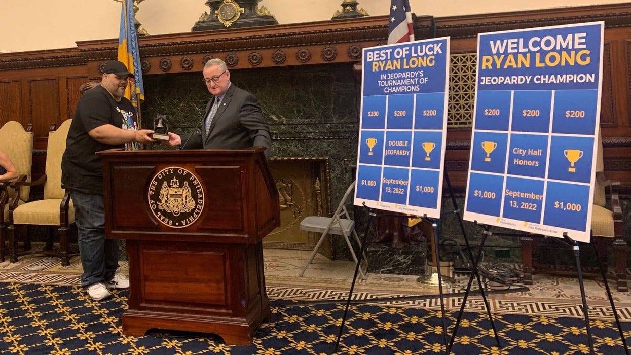 Mayor Jim Kenney awards Ryan Long with a model of the Liberty Bell for his achievements on "Jeopardy!"