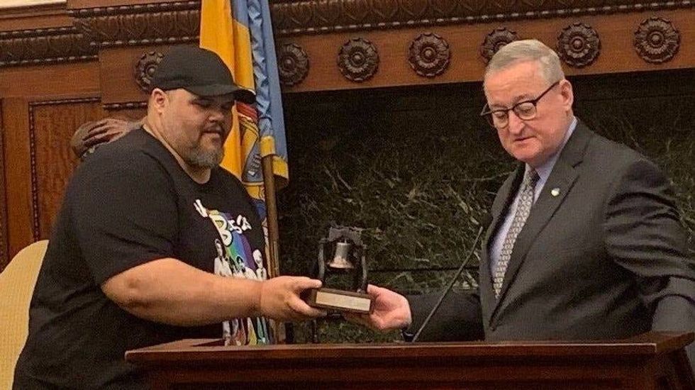 Mayor Jim Kenney awards Ryan Long with a model of the Liberty Bell for his achievements on "Jeopardy!"