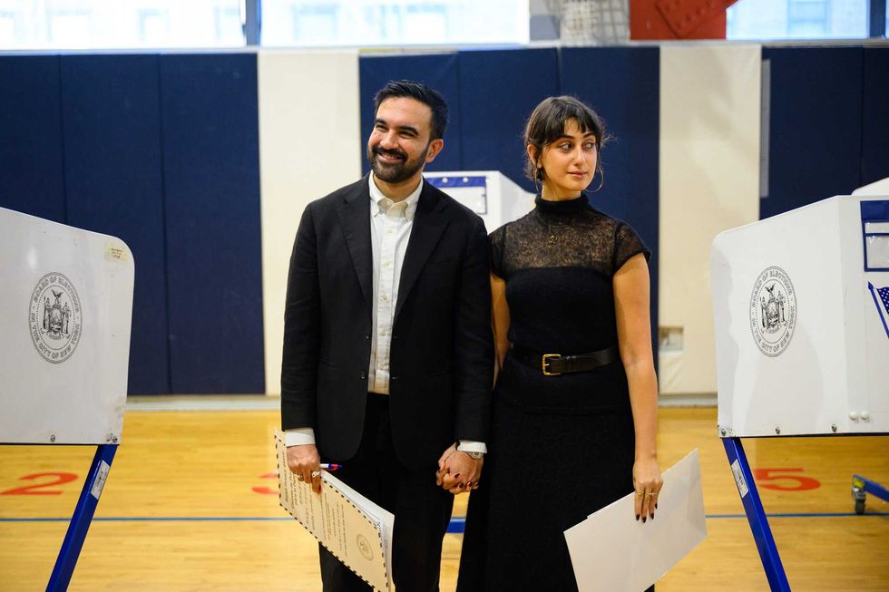 Mayoral Candidate Zohran Mamdani and his wife, Rama Duwaji, pose for media after voting at The Frank Sinatra School of the Arts on Nov. 4, 2025