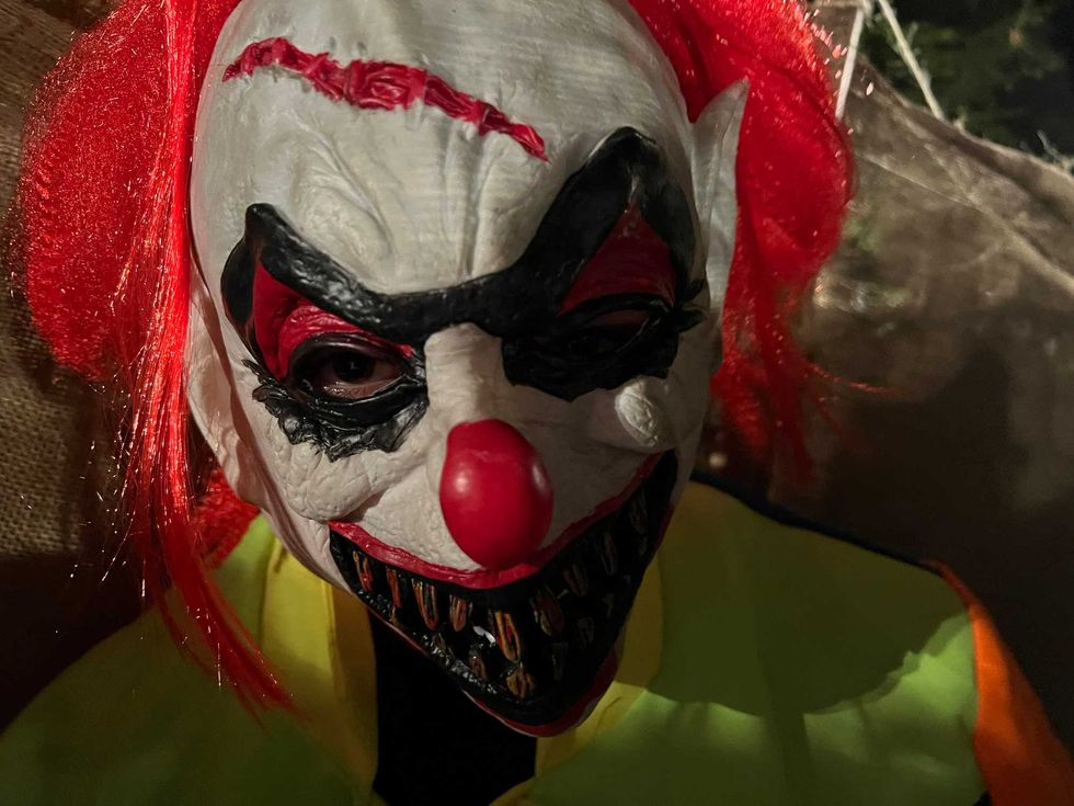 Maze master dressed as clown in maze