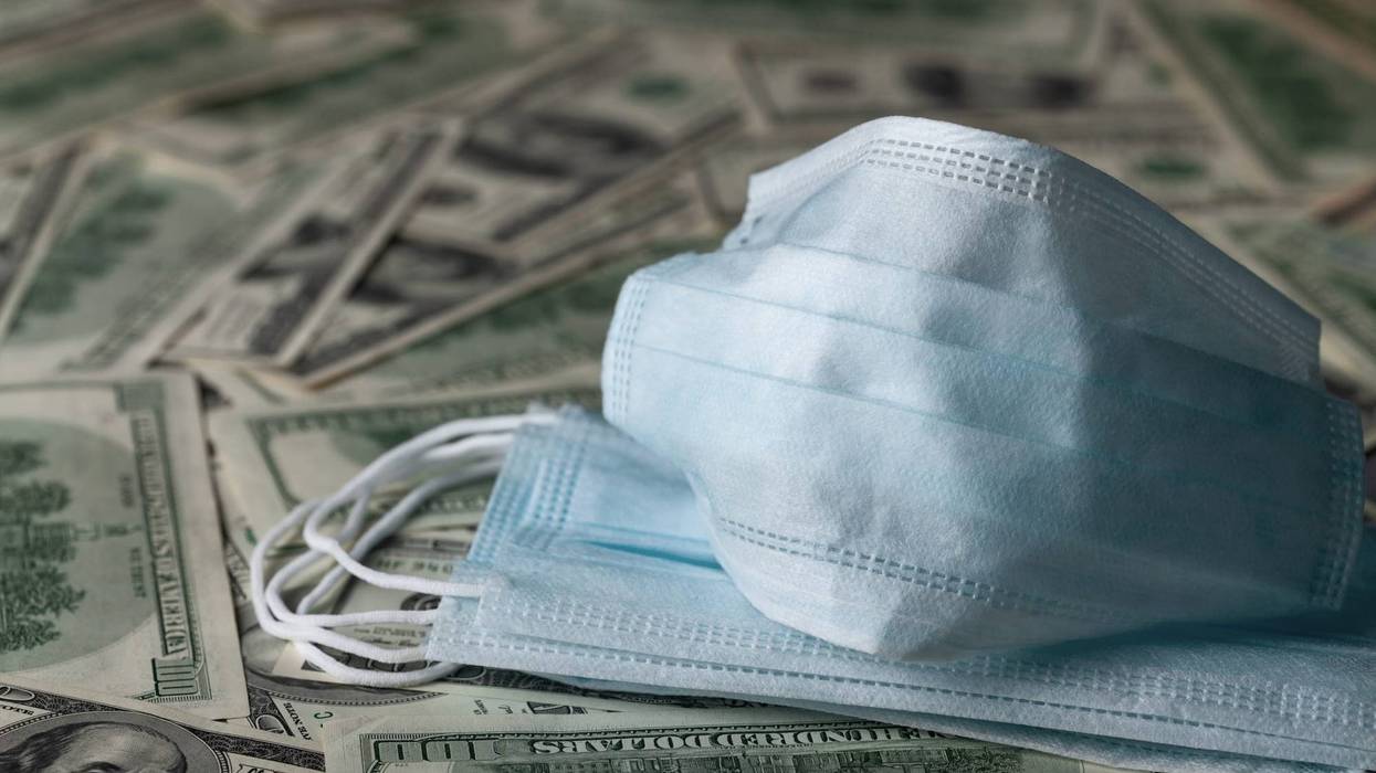 Medical face masks and dollars