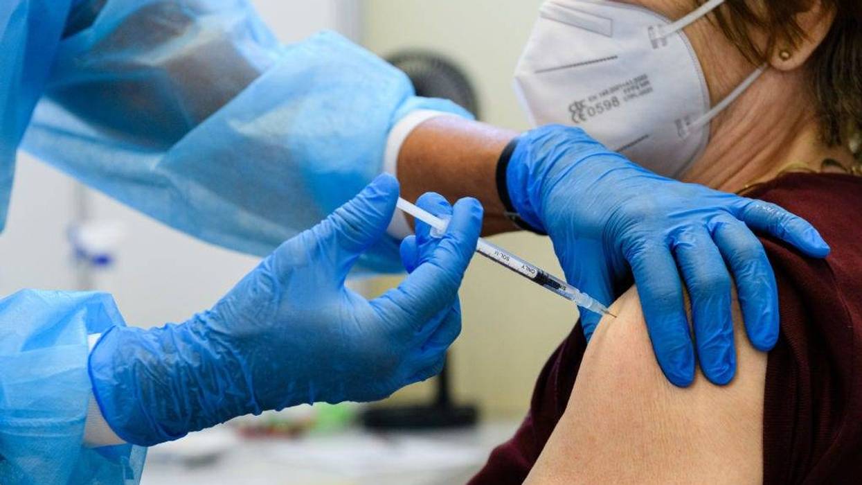 Medical staff member inoculates an elderly patient with a booster inoculation of the Pfizer/BioNTech vaccine against Covid-19 on September 15, 2021 in Erfurt, Germany.