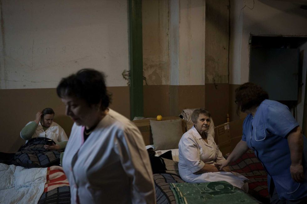 Medical staff rest in a basement used as a bomb shelter at the Ohmatdyt children