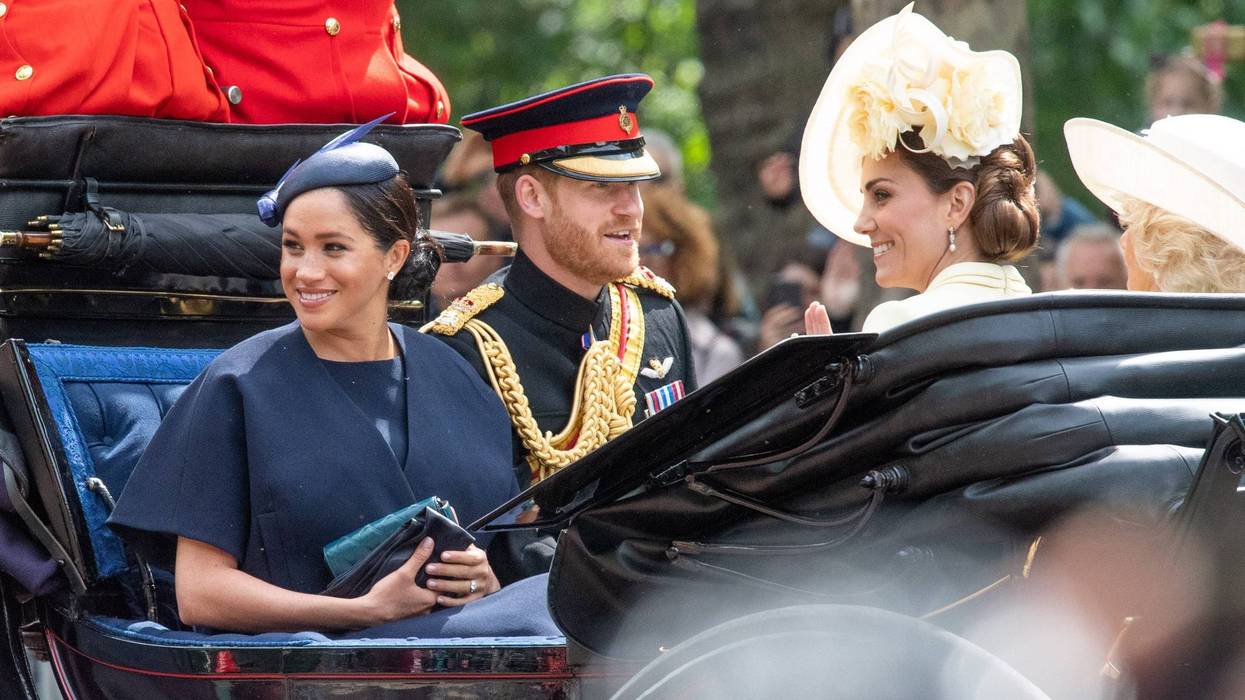 Meghan, Duchess of Sussex rides in an open carriage with Prince Harry, Duke of Sussex and Catherine, Duchess of Cambridge