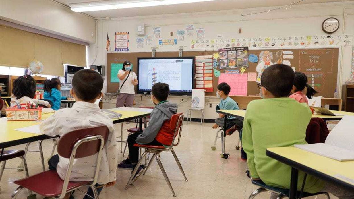 Melissa Wong, a teacher at Yung Wing School P.S. 124 gives a lesson to her masked students in their classroom on September 27, 2021 in New York City.