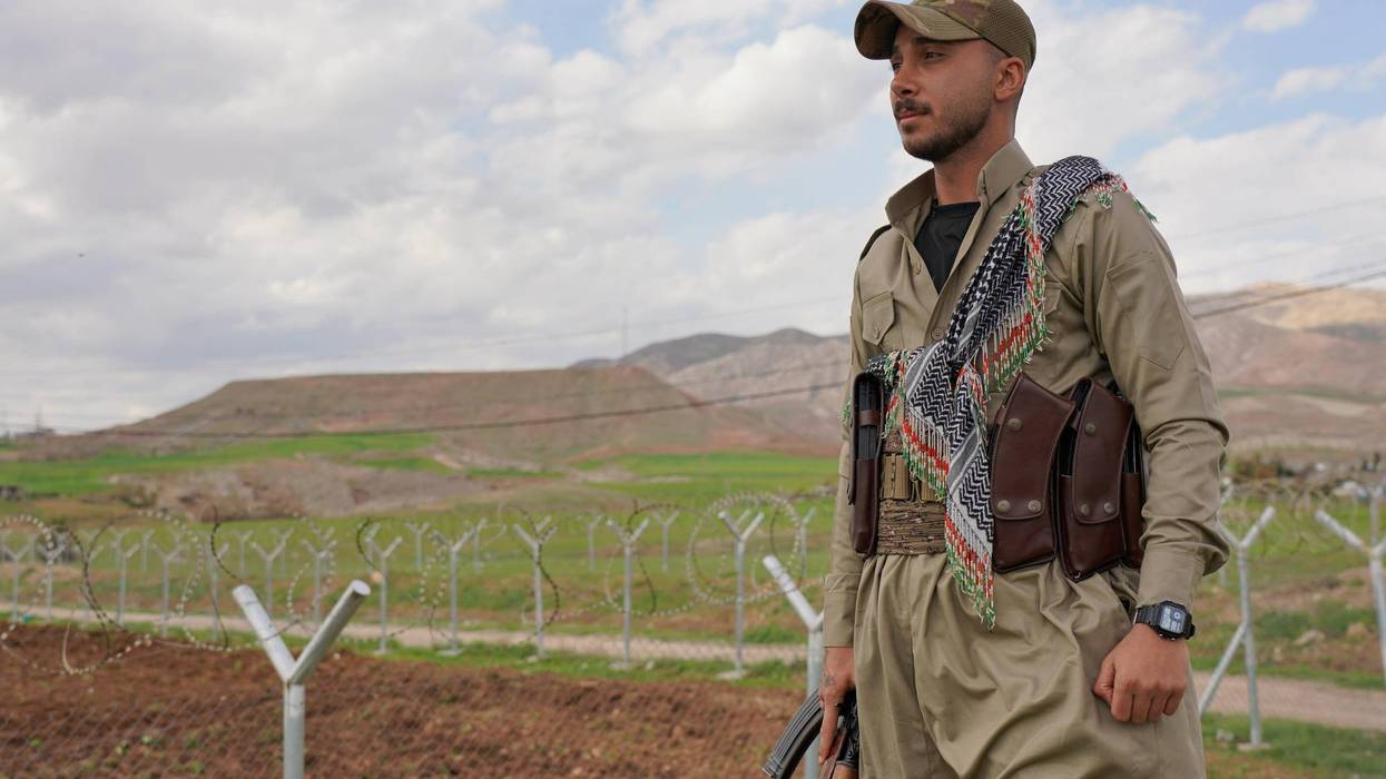 Member of the Democratic Party of Iranian Kurdistan PDKI stands at a checkpoint leading to their base in Koya district of Irbil, Iraq, Friday, Feb. 27, 2026.