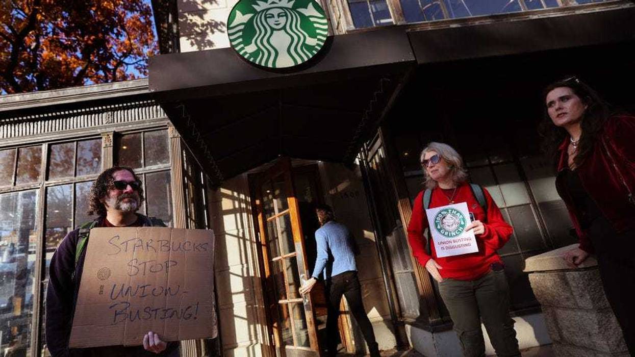 Members and supporters of Starbucks Workers United protest outside of a Starbucks store in Dupont Circle on November 16, 2023 in Washington, DC. The group held a series of rallies on Starbuck's promotional "Red Cup Day" outside of non-union Starbucks stores to demand Starbucks respect union rights. (Photo by Kevin Dietsch/Getty Images)
