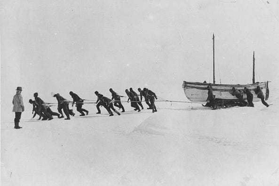 Members of an expedition team led by Irish explorer Sir Ernest Henry Shackleton pull one of their lifeboats across the snow in the Antarctic, following the loss of the