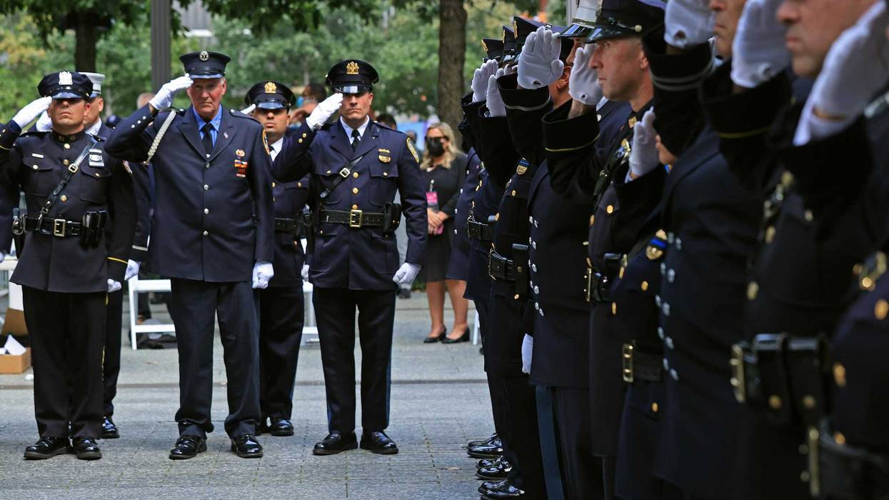 Members of the 9/11 Honor Guard salute at the end of their duty at the National 9/11 Memorial at the conclusion of a commemoration ceremony on Sept. 11, 2021.