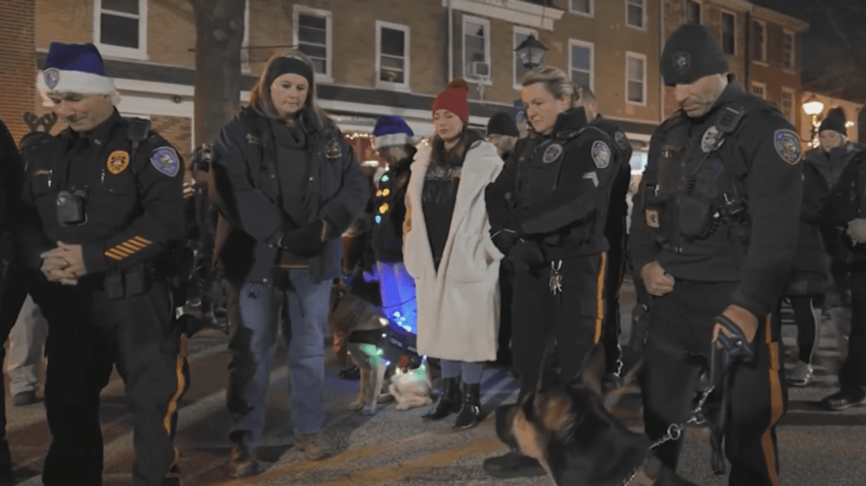 Members of the community who know crossing guard Bruce Morlack held a moment of silence for him during Saturday's holiday parade.