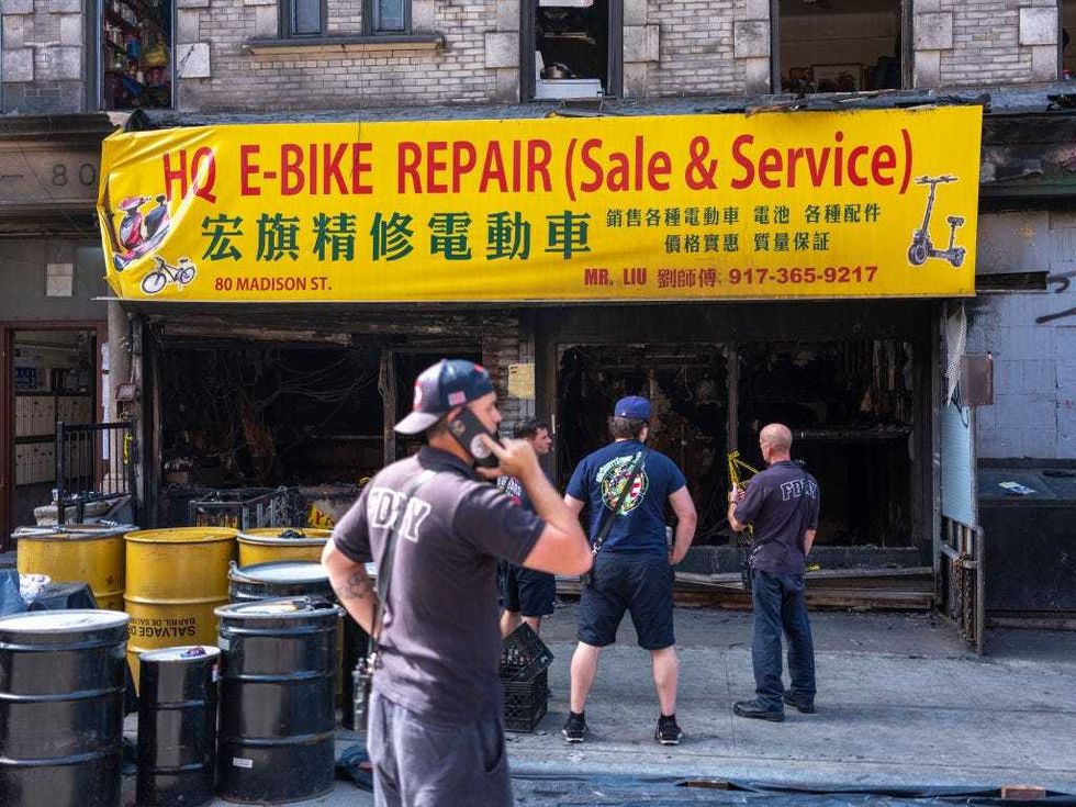 Members of the FDNY inspect an e-bike repair and recharging shop that caught fire and killed 4 people June 28, 2023 in New York City. The fire started from a lithium-ion battery used to charge e-bikes and tore through the six-story building.