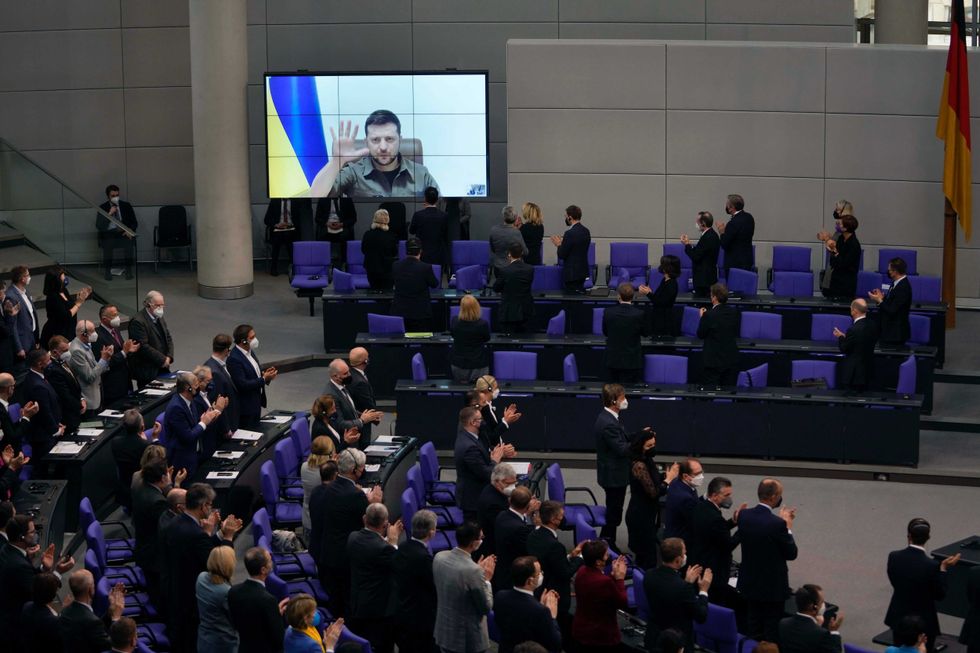 Members of the German parliament Bundestag give Ukraine President Volodymyr Zelenskyy a standing ovation after he speaks in a virtual address to the parliament at the Reichstag Building in Berlin, Germany, Thursday, March 17, 2022