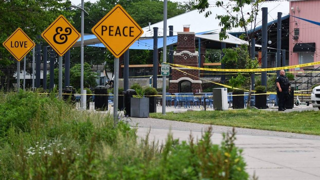 Members of the Lansing Police Department work at the scene of an early morning shooting, on Monday, May 27, 2024, in the 300 block of Riverfront Drive.