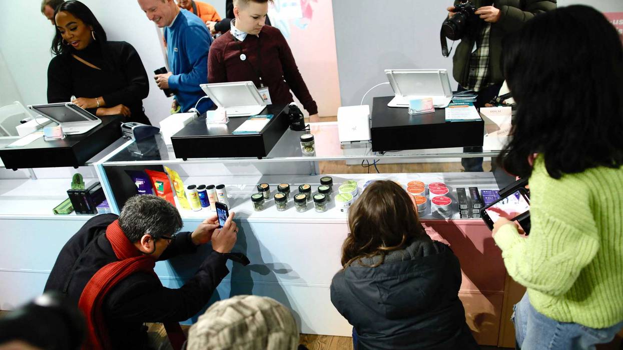 Members of the media take pictures before a press conference at the Housing Works Cannabis Company during the opening of the first legal cannabis dispensary in New York City on Dec. 29, 2022