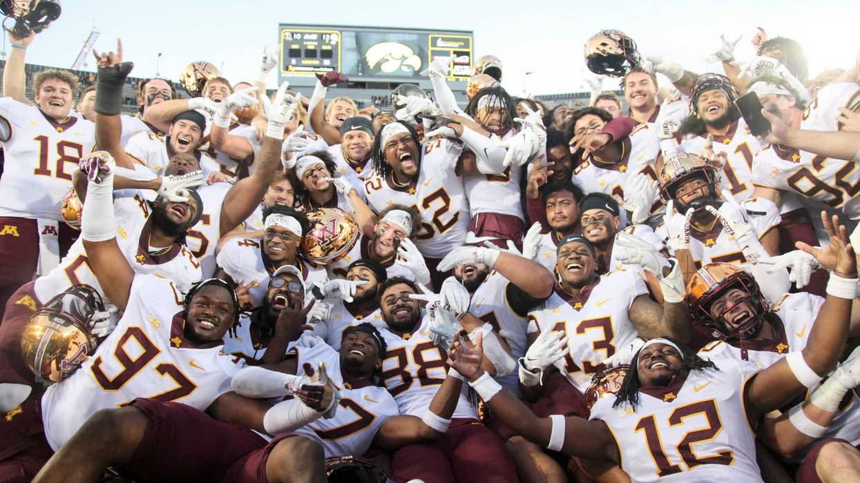 Members of the Minnesota Golden Gophers celebrate with the Floyd of Rosedale trophy after their match-up against the Iowa Hawkeyes at Kinnick Stadium on October 21, 2023 in Iowa City, Iowa.