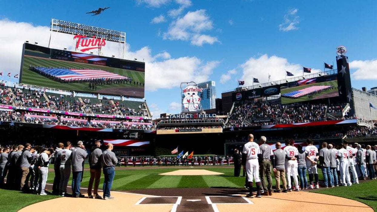 Members of the Minnesota Twins line up for the national anthem before the home opener at Target Field on April 4, 2024 in Minneapolis, Minnesota.