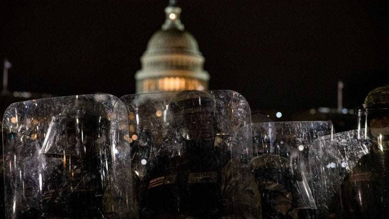 Members of the National Guard and the Washington D.C. police stand guard to keep demonstrators away from the U.S. Capitol on January 06, 2021 in Washington, DC. A pro-Trump mob stormed the Capitol earlier, breaking windows and clashing with police officers. Trump supporters gathered in the nation's capital to protest the ratification of President-elect Joe Biden's Electoral College victory over President Donald Trump in the 2020 election.
