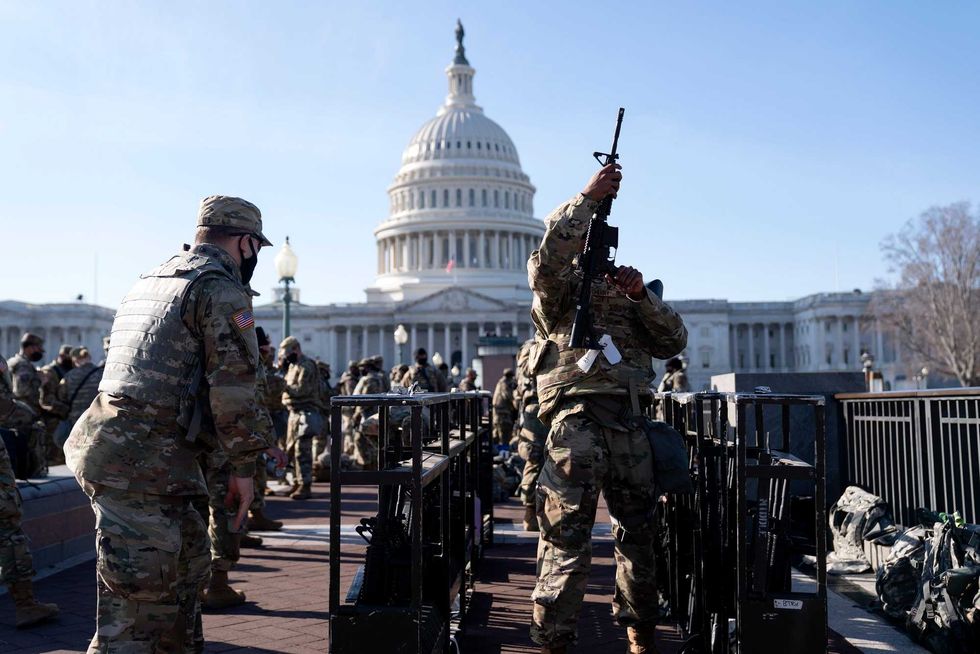 Members of the National Guard prepare to distribute weapons outside the U.S. Capitol on January 14, 2021 in Washington, DC. Security has been increased throughout Washington following the breach of the U.S. Capitol last Wednesday, and leading up to the Presidential Inauguration.