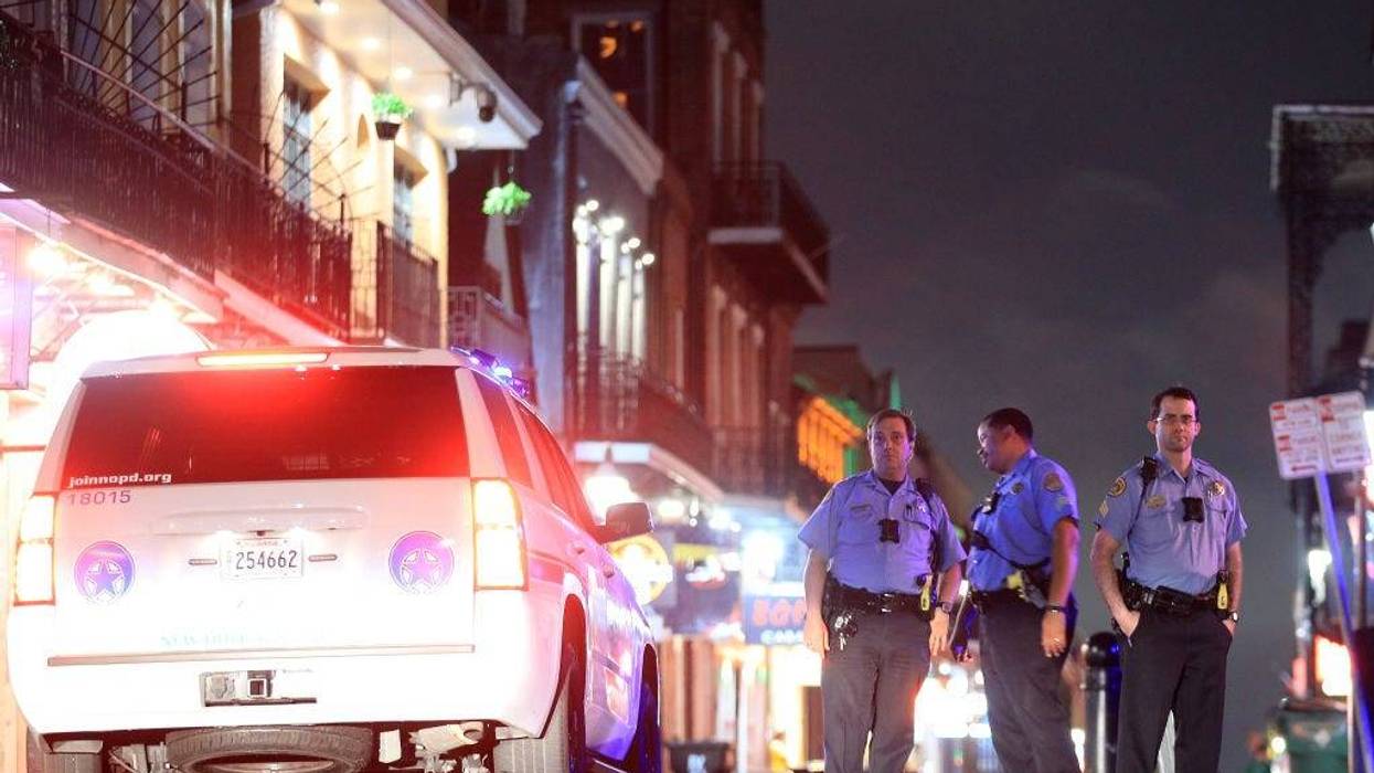 Members of the New Orleans Police Department stand on Bourbon Street