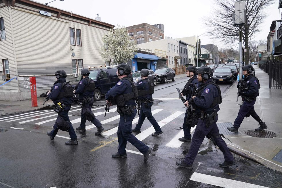 Members of the New York Police Department patrol the streets after 16 people were injured during a rush-hour shooting at a subway station in the New York borough of Brooklyn on April 12, 2022, where authorities said "several undetonated devices" were recovered amid chaotic scenes.