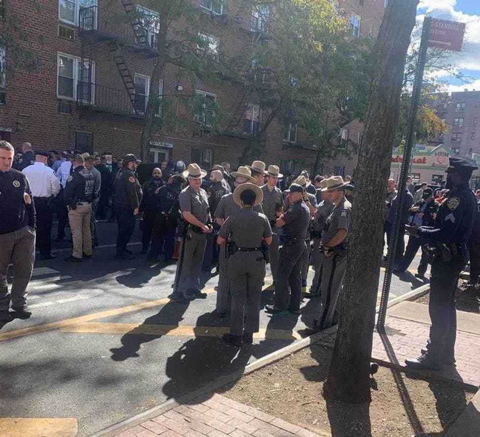 Members of the NYPD and New York State Police are seen near Roosevelt Avenue on Oct. 15, 2024