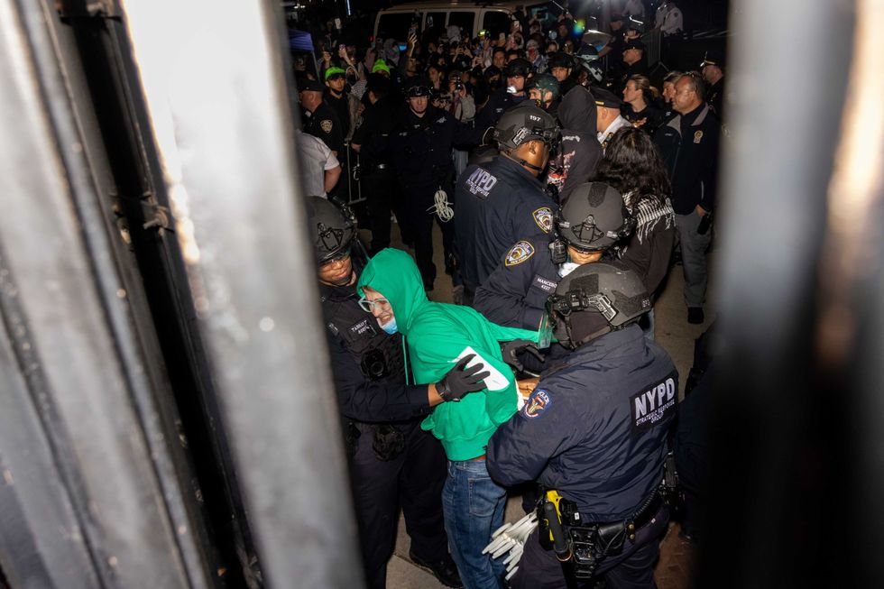 Members of the NYPD arrest protesters blocking the entrance to Columbia University while clearing the pro-Palestinian protest encampment and Hamilton Hall on April 30, 2024
