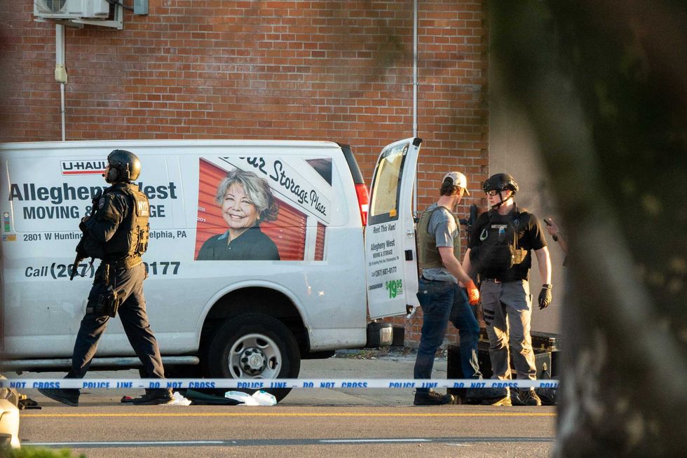 Members of the NYPD bomb squad inspect a U-Haul van in Gravesend believed to be linked to the subway shooting on April 12, 2022
