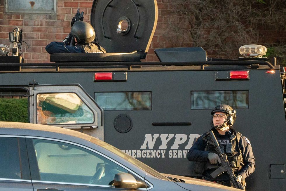 Members of the NYPD bomb squad inspect a U-Haul van in Gravesend believed to be linked to the suspect of a shooting in the subway on April 12, 2022