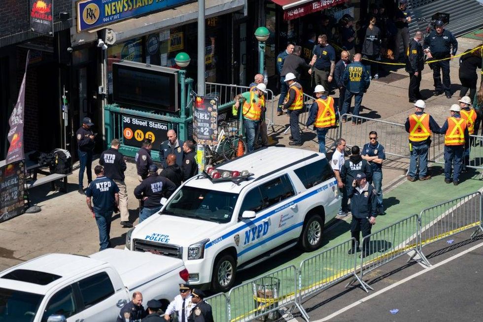 Members of the NYPD gather at the site of a shooting at the 36 St subway station on April 12, 2022 in New York City. According to authorities, at least 29 people were reportedly injured, including 10 with gunshot wounds, during a shooting at the 36th Street and Fourth Avenue station in the Sunset Park neighborhood.