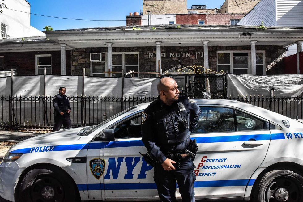 Members of the NYPD patrol in front of a synagogue on Oct. 13, 2023 in Williamsburg