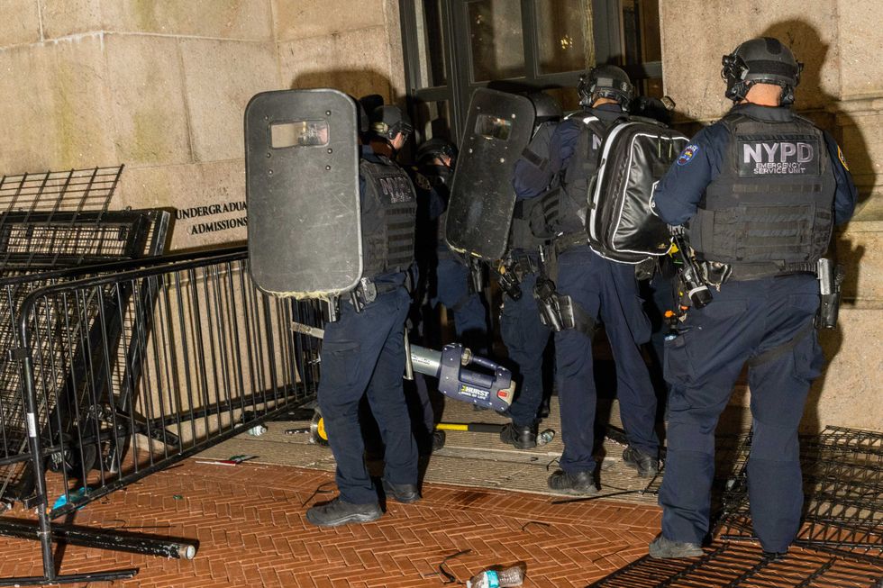 Members of the NYPD surround and breach Hamilton Hall where demonstrators barricaded themselves inside on the Columbia University campus on April 30, 2024.