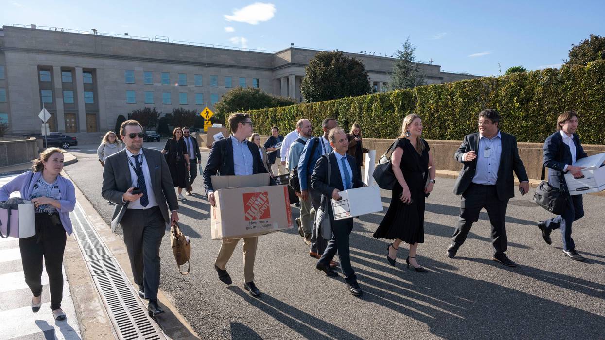 Members of the Pentagon press corp carry their belongings out of the Pentagon after turning in their press credentials, Wednesday, Oct. 15, 2025 in Washington.