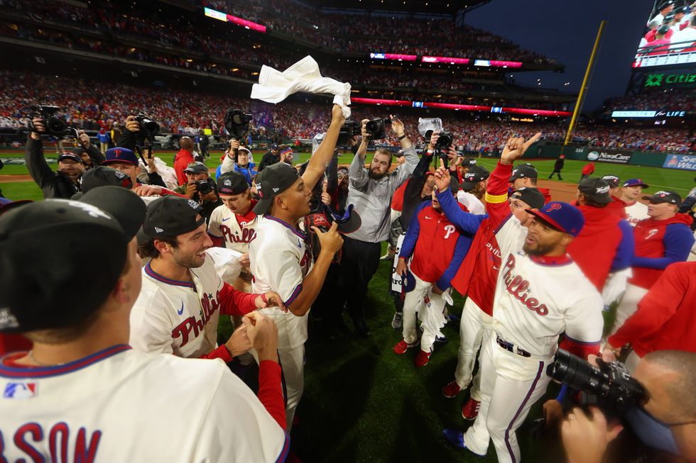 Members of the Philadelphia Phillies celebrate after defeating the San Diego Padres in game five to win the National League Championship Series at Citizens Bank Park on October 23, 2022 in Philadelphia, Pennsylvania.