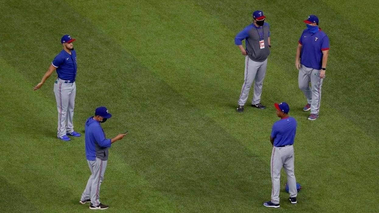 Members of the Texas Rangers pitching staff and coaches warm up during Major League Baseball Summer Workouts at Globe Life Field on July 03, 2020 in Arlington, Texas.