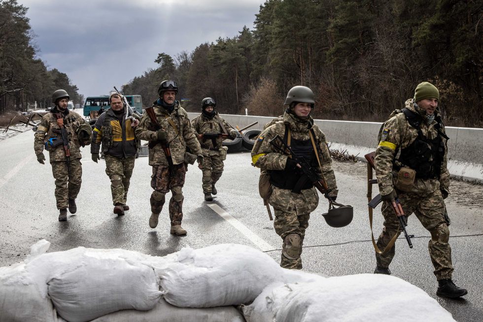 Members of the Ukrainian military arrive to reinforce a forward position on the eastern frontline near Kalynivka village on March 08, 2022, in Kyiv, Ukraine