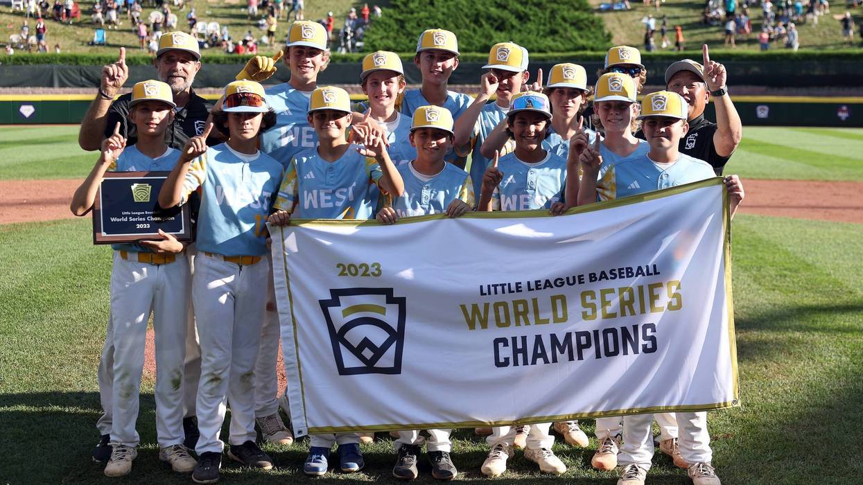Members of the West Region team from El Segundo, California pose with the championship banner after defeating of the Caribbean Region team from Willemstad, Curacao to win the Little League World Series Championship Game at Little League International Complex on August 27, 2023 in South Williamsport, Pennsylvania.