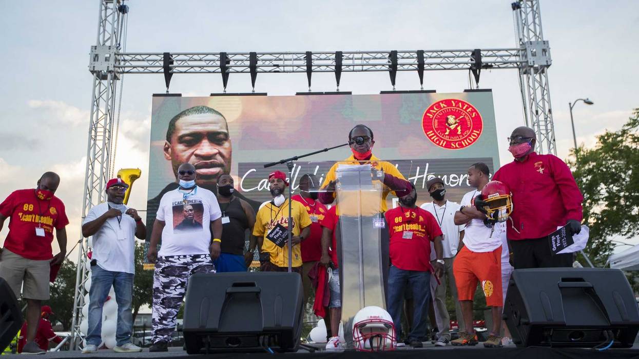Members of the Yates High School championship football team speak during a candlelight vigil honoring George Floyd on Monday, June 8, 2020, at Jack Yates High School football field.
