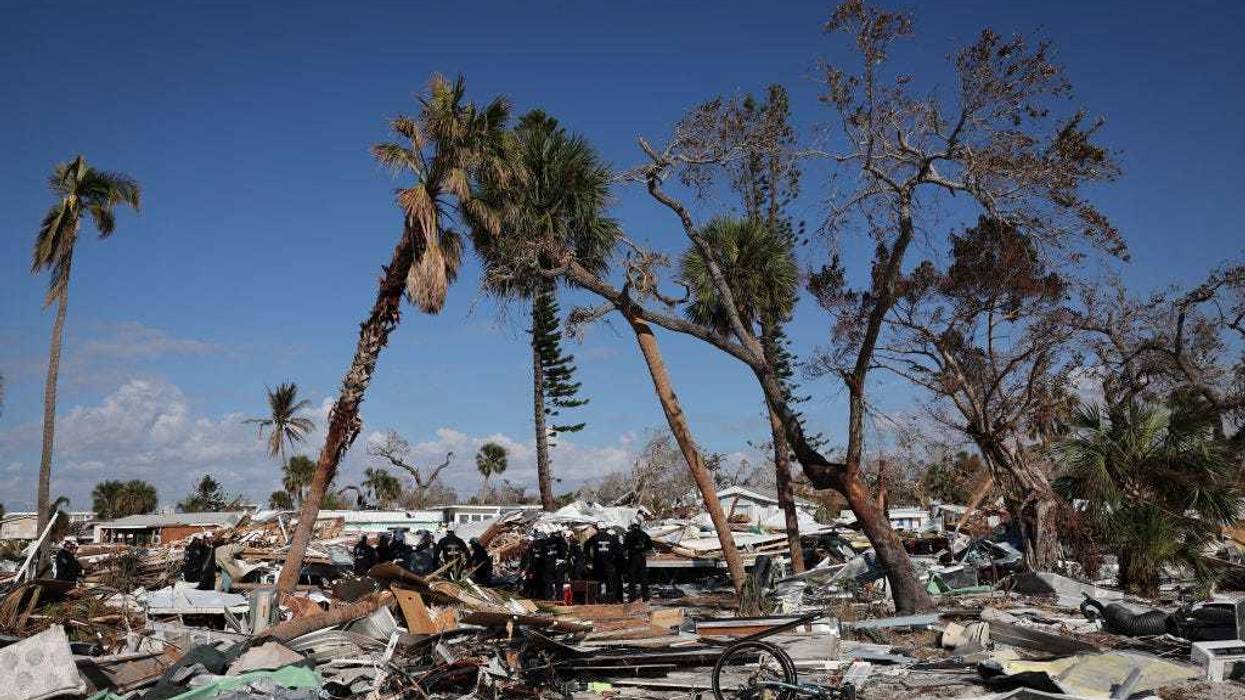 Members of Virginia Task Force 2 Urban Search and Rescue receive a briefing before combing through the wreckage on Fort Myers Beach looking for victims of Hurricane Ian October 04, 2022 in Fort Myers Beach, Florida.