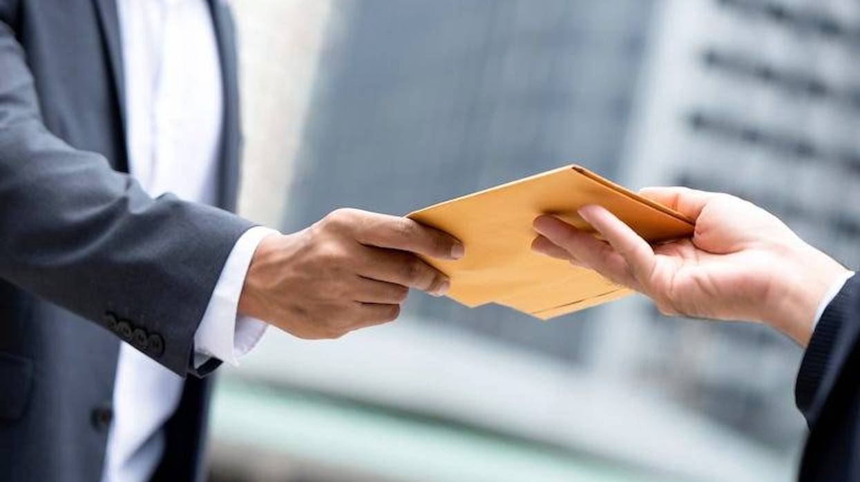 Men exchanging papers