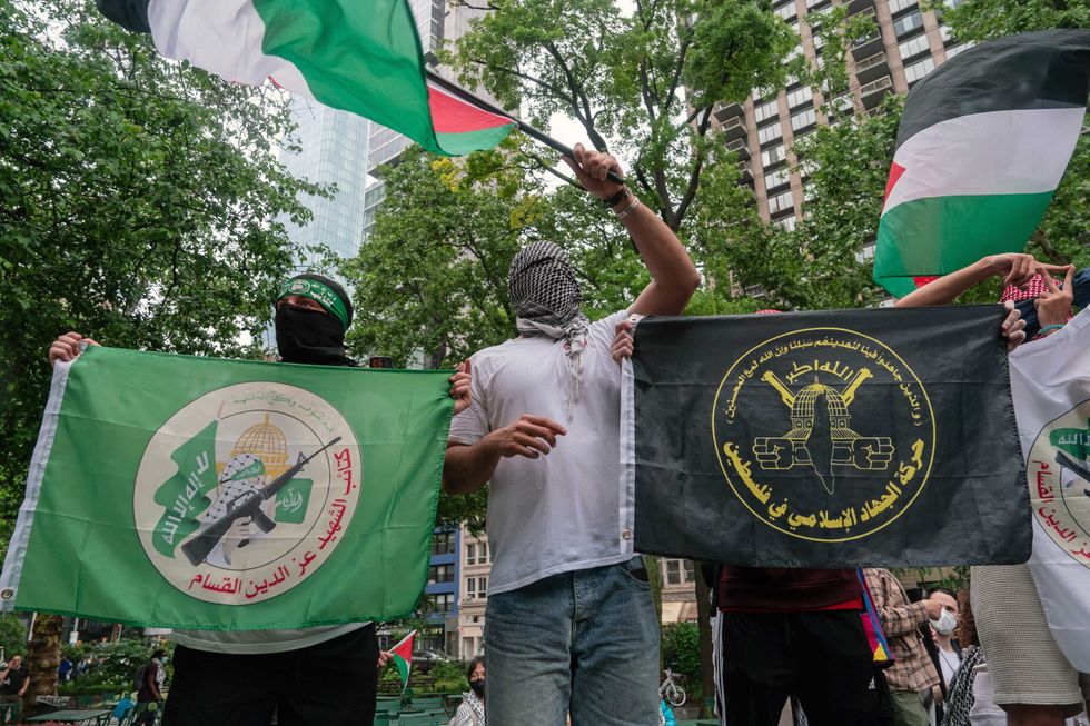 Men hold Hamas flags during a rally in New York City on May 27, 2024.