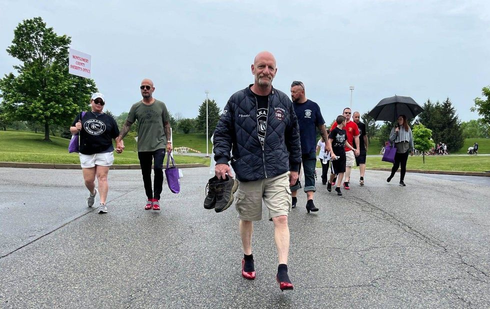 Men participating in the "Walk a Mile in Her Shoes" event in Collegeville, Pa.
