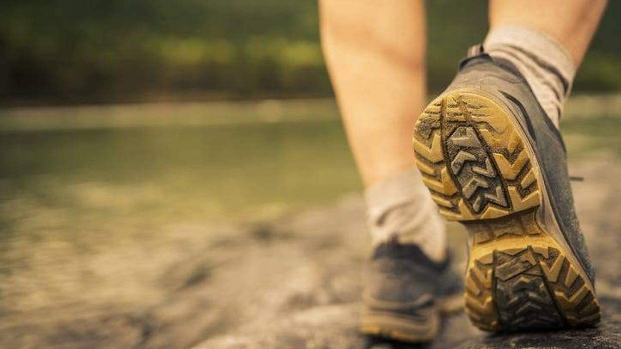Men's footsteps on the beach of river