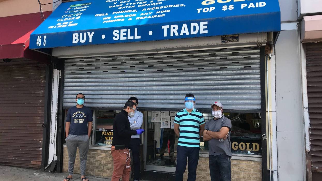 Men standing in front of MN Wireless on 52nd Street